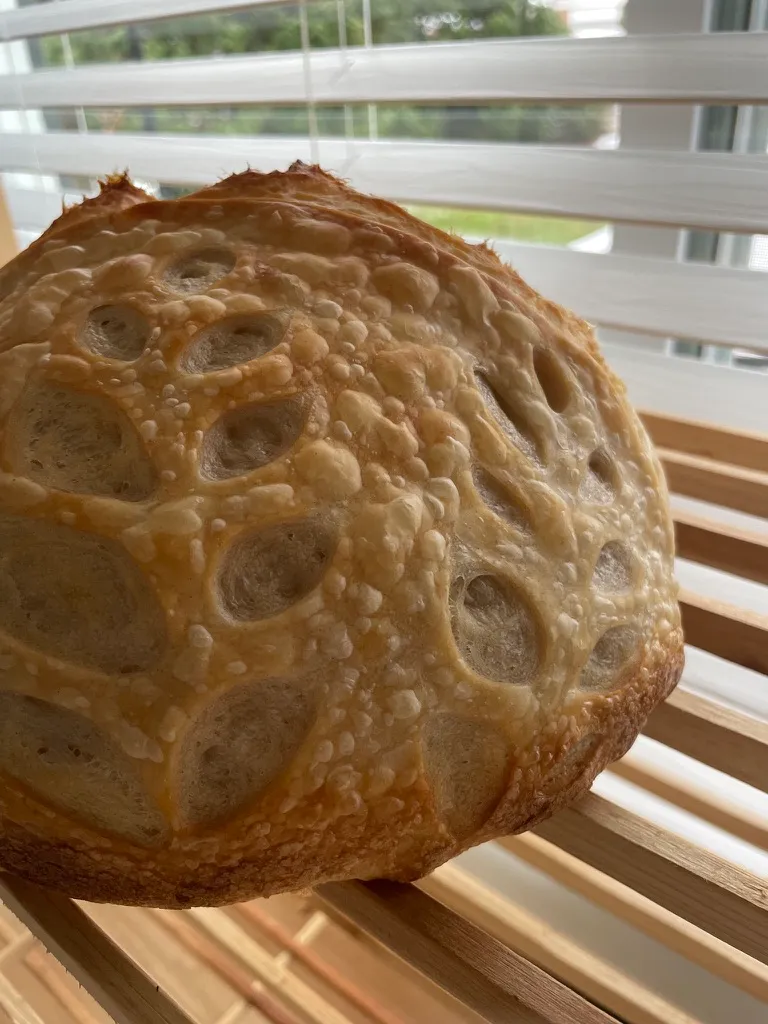 Rustic country loaf with a hearty, flour-dusted crust on a linen cloth