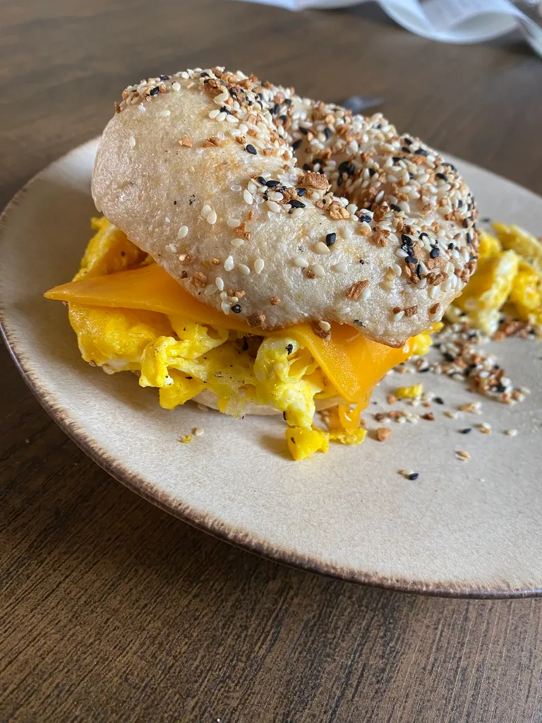 Classic sourdough boule on a wooden board, showing a golden crust and flour-dusted top