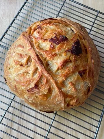 Artisan bâtard loaf with golden-brown crust and soft crumb visible at the cut